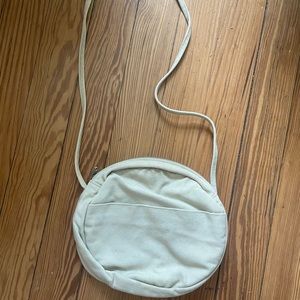 Baggu round canvas purse in light green.